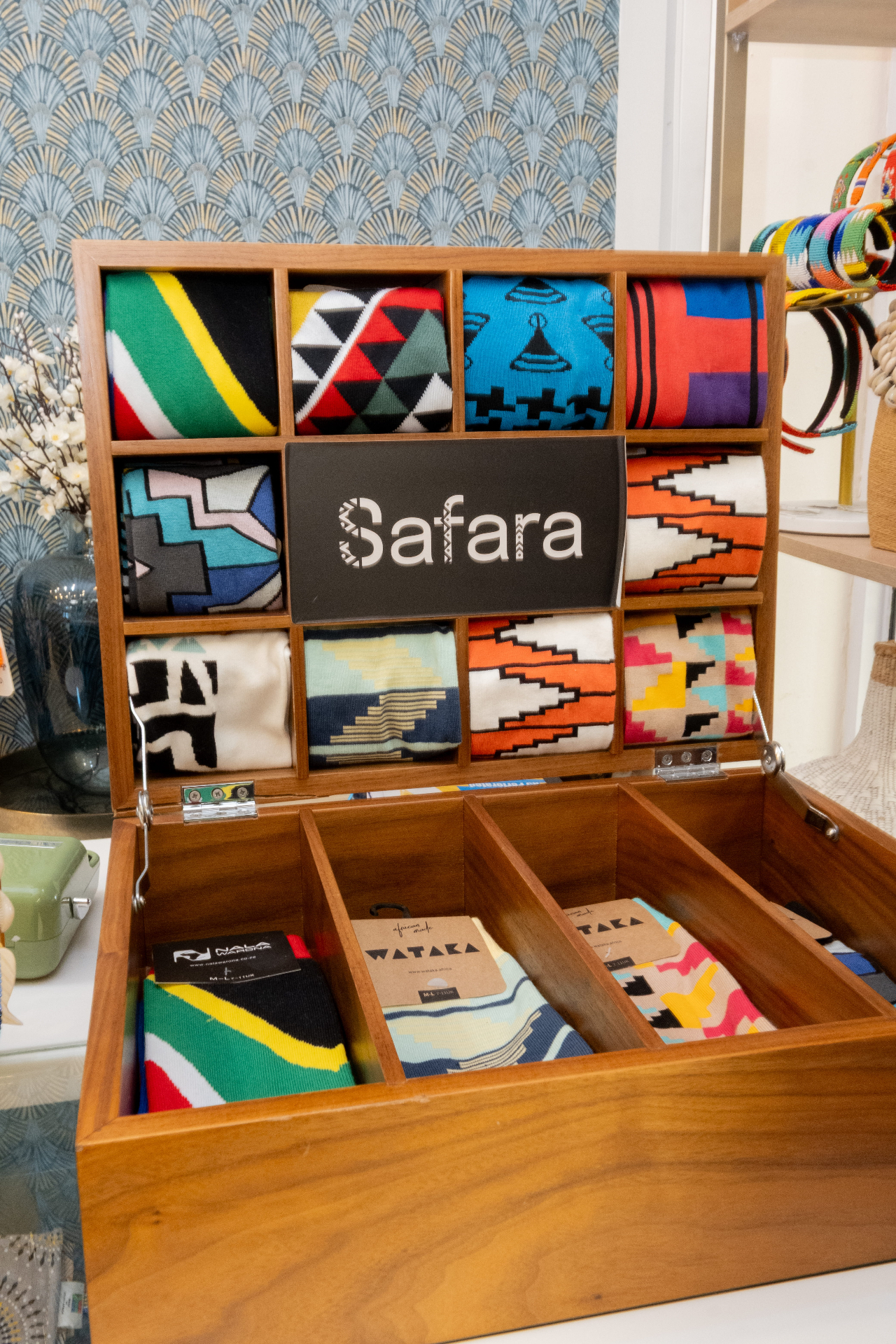 Safara branded African-pattern socks displayed in a wooden gift box at the Camps Bay store